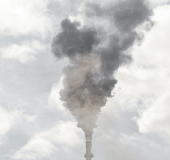 Factory chimney with polluting smoke billowing above