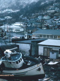 A boat in a street of a village after a flood