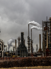 A large industrial building, with chimneys and pollution